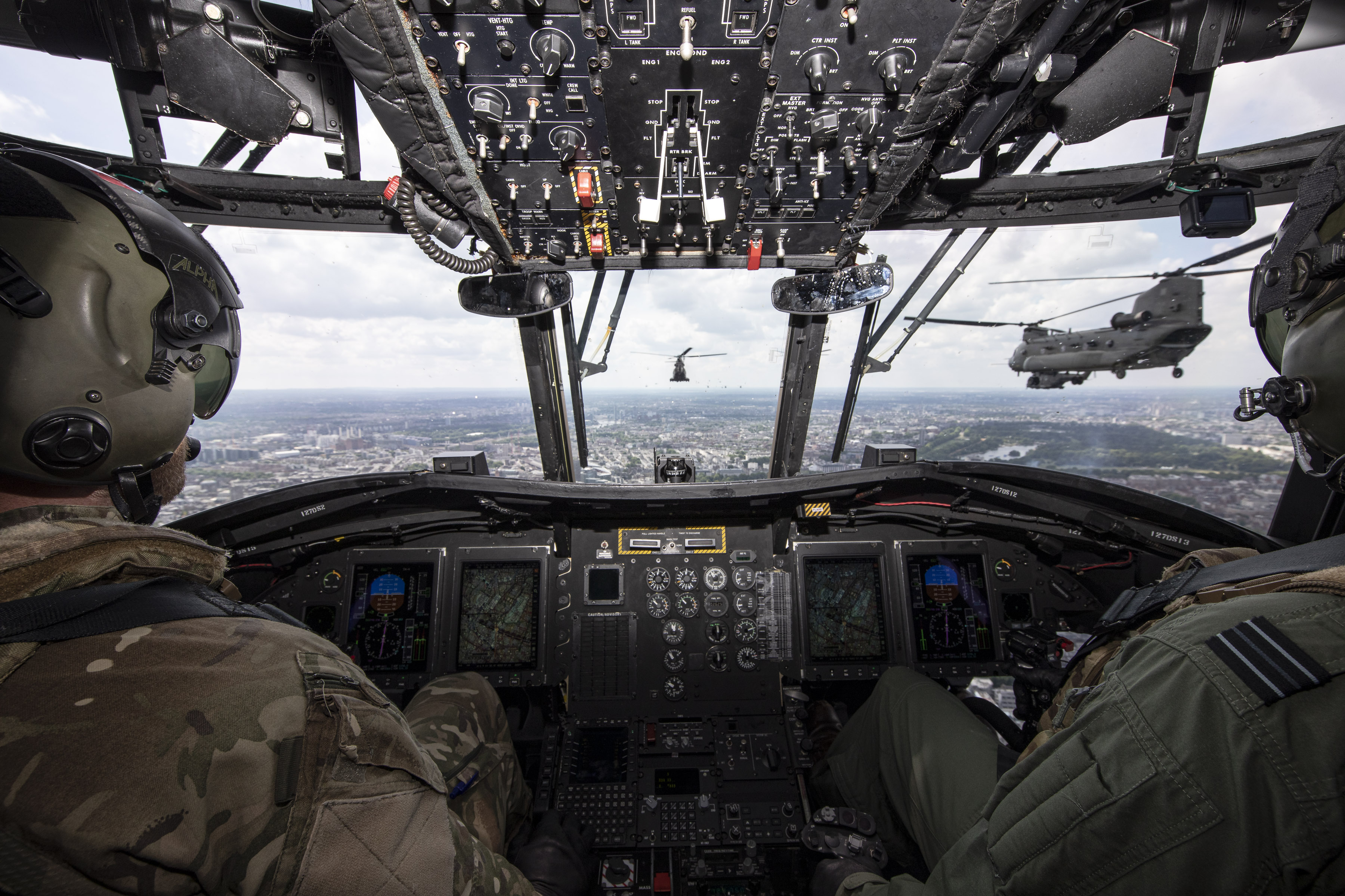 Aviators inside Chinooks in formation during flypast.